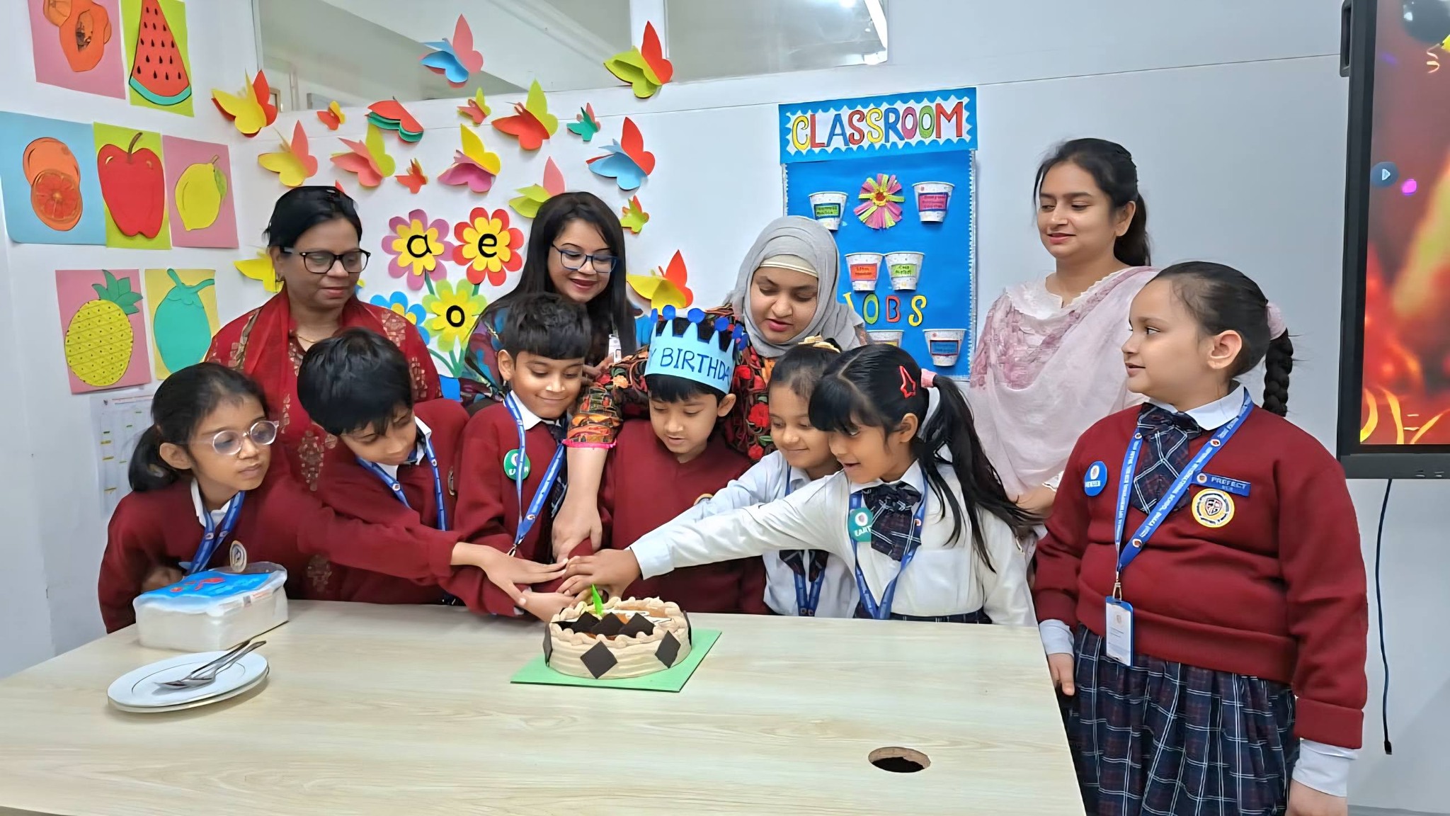Students and teachers celebrating a birthday in the classroom